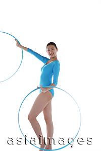 Asia Images Group - Rhythmic gymnast performing with hoop