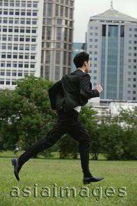 Asia Images Group - Businessman running through the park