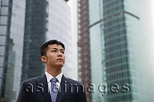 Asia Images Group - Businessman looking away, buildings in the background