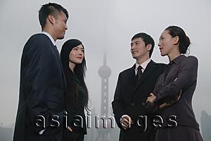 Asia Images Group - Business people talking, Oriental Pearl TV Tower in the background
