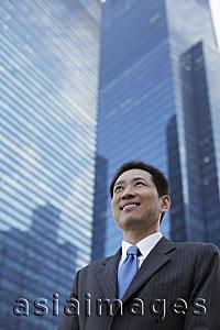 Asia Images Group - Mature man in a business suit, smiling in front of a building