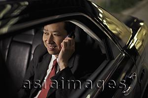 Asia Images Group - Mature man sitting in car talking on phone