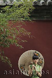 Asia Images Group - Young woman wearing Chinese traditional dress holding an umbrella