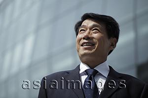 Asia Images Group - Mature man wearing a suit looking up