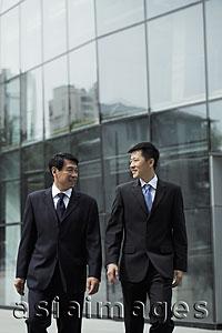 Asia Images Group - Businessmen walking together in front of a building