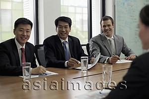 Asia Images Group - Businessmen having a meeting at a conference table
