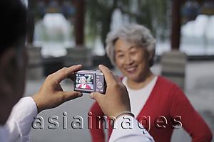 Asia Images Group - Older woman having her photo taken.