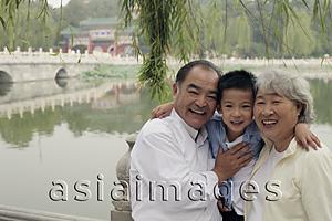 Asia Images Group - Grandfather, grandmother and grandson hugging in park