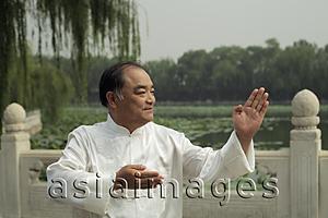 Asia Images Group - Older man doing Tai Chi in a park, Beijing, China