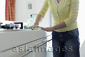 Asia Images Group - Cropped shot of woman wiping kitchen counter