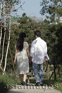 Asia Images Group - Rear view of young couple walking down a path