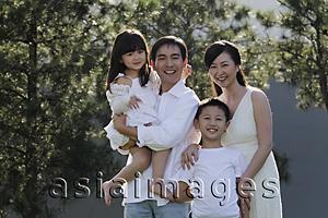 Asia Images Group - Family of four smiling outdoors