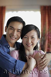 Asia Images Group - Young couple embracing in their home