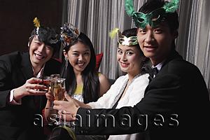 Asia Images Group - Two couples toasting each other at a party