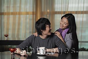 Asia Images Group - Young couple at cafe looking at each other