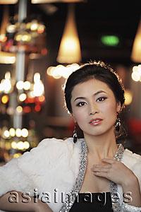 Asia Images Group - Head shot of elegantly dressed woman at night