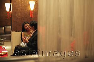 Asia Images Group - Young couple sitting in a club at night