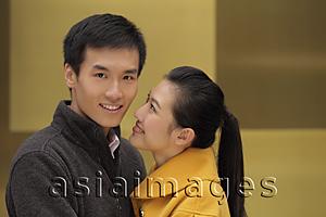 Asia Images Group - Young woman looking at young man while he looks at camera