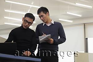 Asia Images Group - Two men working together in an office