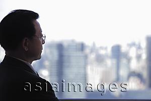 Asia Images Group - Profile of man wearing glasses looking out the window