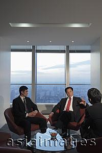 Asia Images Group - Three businessmen talking in office