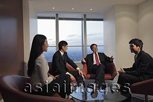 Asia Images Group - Four people having a meeting in an office