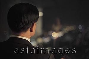 Asia Images Group - Rear view of businessman looking out of a window
