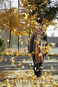 Asia Images Group - Young leaves falling on young boy