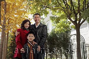 Asia Images Group - Family with young boy standing in front of their house