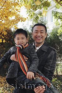 Asia Images Group - Dad holding his son outdoors