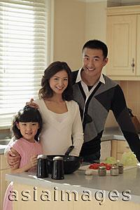 Asia Images Group - Young family cooking together in kitchen