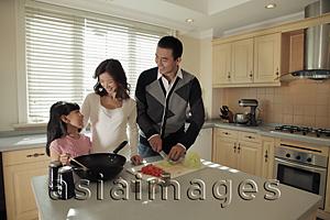 Asia Images Group - Young family cooking together in the kitchen