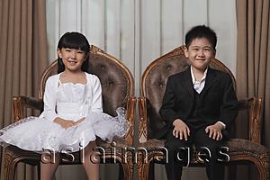 Asia Images Group - Young boy and girl dressed in nice clothes smiling