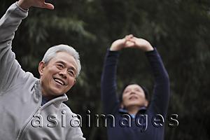 Asia Images Group - Two older men stretching outdoors