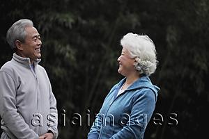 Asia Images Group - A senior couple in sweatsuits talking together