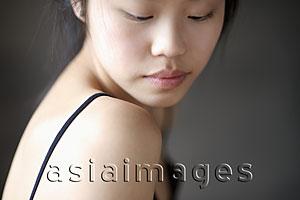 Asia Images Group - Head shot of woman looking over her shoulder