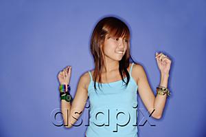 AsiaPix - Young woman against blue background, looking away