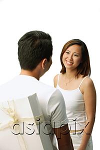 AsiaPix - Couple facing each other, man with present behind his back, woman smiling