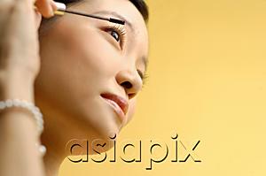 AsiaPix - Woman putting on mascara