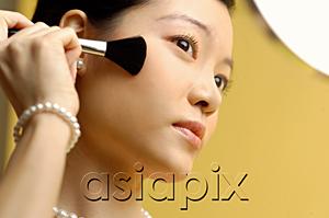 AsiaPix - Woman putting on blusher