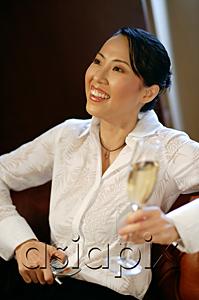 AsiaPix - Woman with champagne glass and mobile phone, looking away, smiling