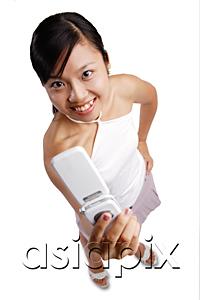AsiaPix - Young woman holding mobile phone, looking at camera