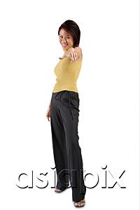 AsiaPix - Young woman standing, hand pointing towards camera