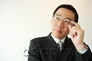 AsiaPix -  Businessman adjusting glasses