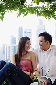 AsiaPix - Young couple sitting and looking at each other