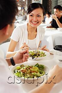 AsiaPix - Couple eating at restaurant, over the shoulder view