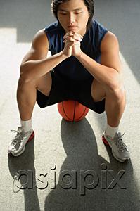 AsiaPix - Man sitting on basketball