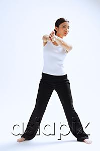 AsiaPix - Woman standing, hands clasped in front of her, legs apart