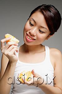 AsiaPix - Woman holding peeled orange
