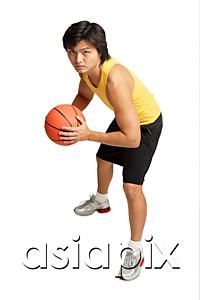 AsiaPix - Man holding basketball, preparing to shoot